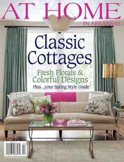 ‘At Home in Arkansas’ magazine cover featuring a beige sofa and green curtains.