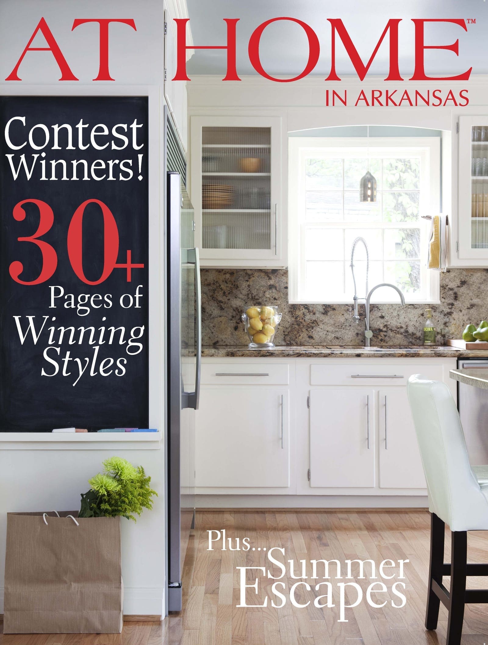 At Home magazine cover featuring a white kitchen with a stainless steel refrigerator.