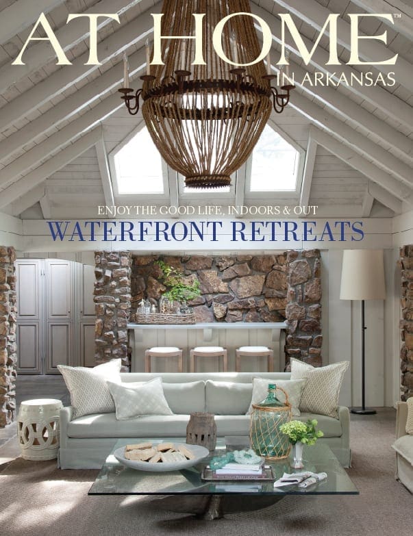 At Home magazine cover: Interior with stone fireplace, chandelier, and seating.