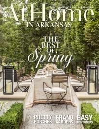 At Home in Arkansas magazine cover featuring a patio table and garden.