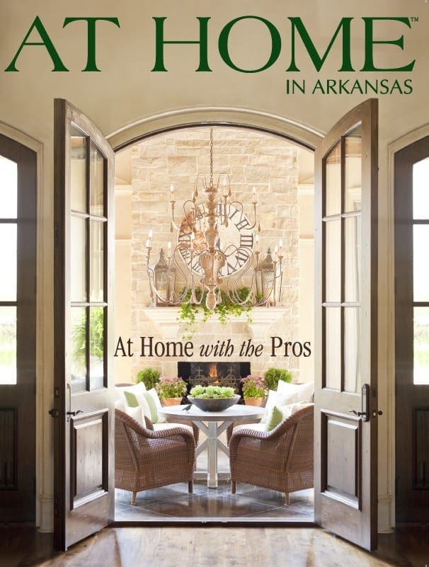‘At Home with the Pros’ magazine cover featuring arched entryway, stone wall, and chandelier.