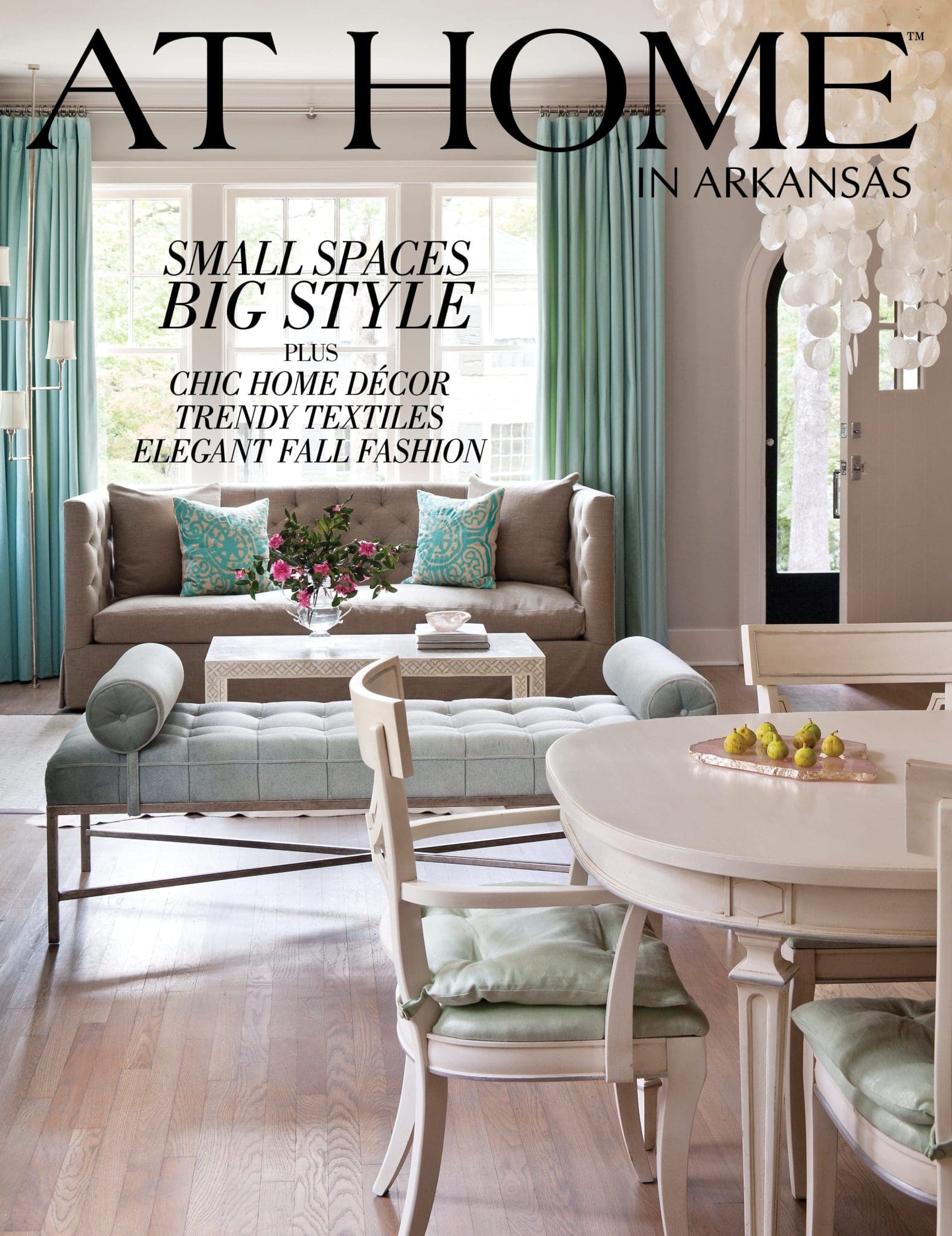 AT HOME magazine cover featuring a sofa, table, and decorative accents.