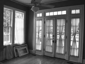 Black and white room with large windows and French doors.