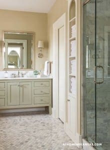 Cream-colored bathroom with marble tile floor and glass shower.
