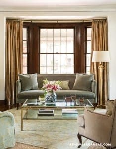 Gray sofa with beige cushions and a coffee table.