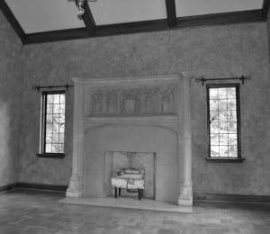 Stone fireplace with arched detailing in a formal room.