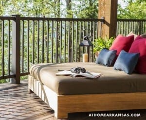 Deck with daybed, pillows, lantern, and greenery.