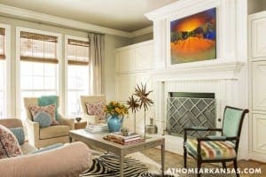 White living room with fireplace, artwork, and furniture.