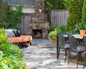 Stone fireplace and patio with outdoor furniture.