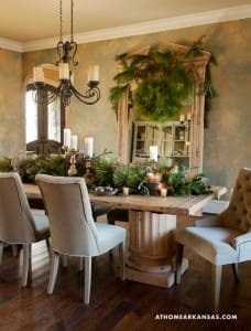 Dining room with a large wooden table, upholstered chairs, and a chandelier.