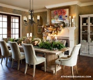 Formal dining room with a large wooden table, chairs, and a fireplace.