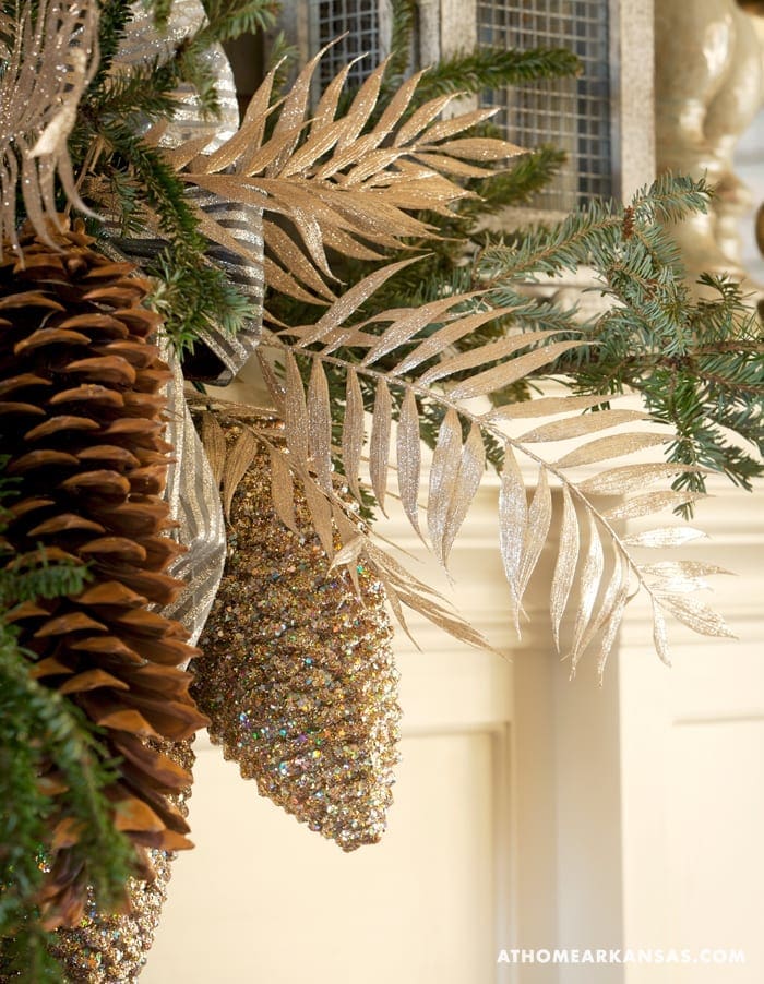 Gold and silver pinecones and foliage on a Christmas tree.