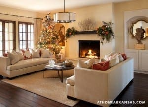 Living room with fireplace, sofa, and Christmas decor.