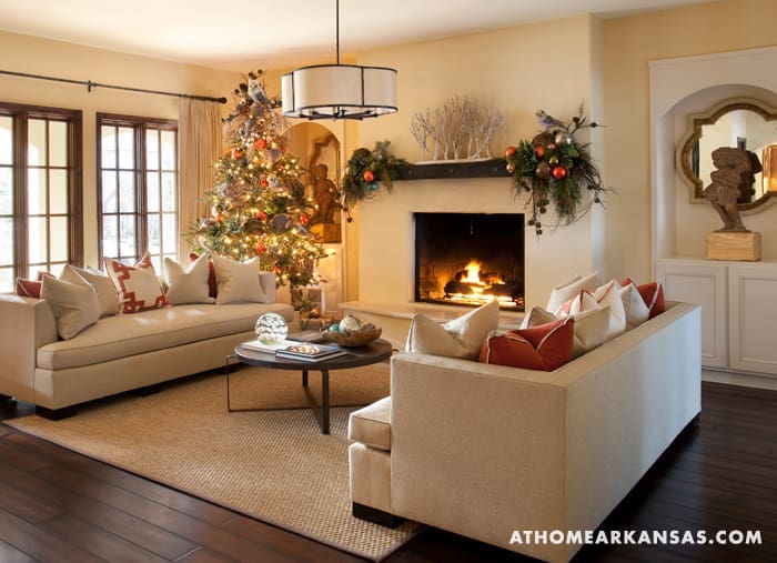 Living room with fireplace, sofa, and Christmas decor.
