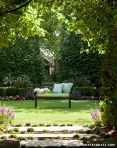 Green lawn with bench and hedges, Arkansas home.