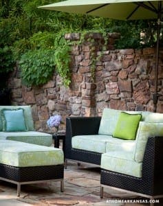 Stone wall with greenery, outdoor seating area