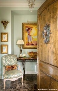 Wooden door with ornate ironwork and a pale blue wall.