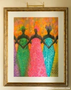 Gold frame displays an abstract painting of figures.