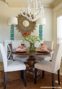 White chandelier with a sunburst design above a dining table.
