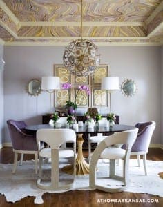 Purple and gold dining room with a marbled ceiling and artwork.