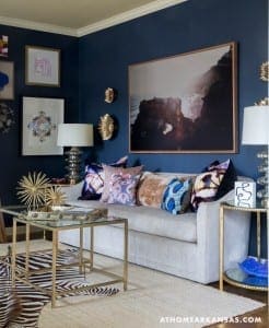 Gray sofa with patterned pillows and a gold coffee table.