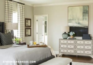 Master bedroom with gray bedding, gray curtains, and a dresser.