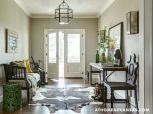 Hallway with dark furniture, patterned rug, and a large lantern.