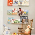 Wooden bookshelf with children’s books and toys, rocking chair.
