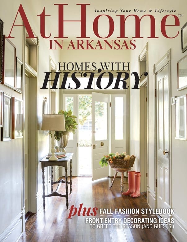 At Home magazine cover featuring a hallway with antique doors and a table.