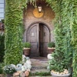 Brick facade with ivy-covered archway and lantern.