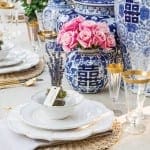 Blue and white porcelain vases with pink roses and gold accents.