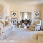 Cream-colored sofa with patterned rug in a formal living room.
