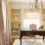 Formal office with a large chandelier, bookshelves, and a desk.