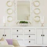 White cabinet with decorative mirror and plates.