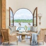Arched window with view of pool and water.