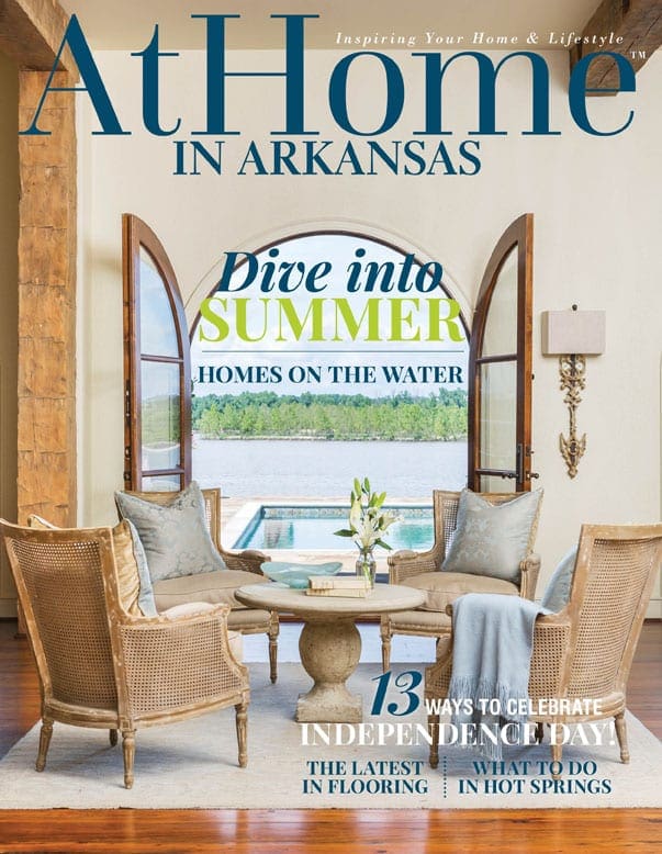 At Home in Arkansas cover featuring waterfront homes, seating, and a summer theme.
