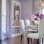 Purple dining room with wallpaper, chairs, and floral arrangement.