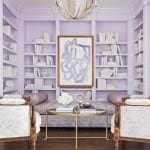 Purple paneled library with built-in shelves and seating.