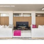 White sectional sofa with pink throw pillows in a modern living room.