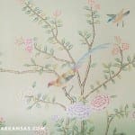 Hand-painted floral and bird design on pale green wallpaper.