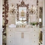 White vanity with ornate mirror and multiple chandeliers.