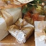 Wrapped gifts with brown ribbon and gold accents.