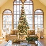 Large arched windows and a decorated Christmas tree in a living room.