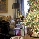 Gray sofa with cat, Christmas tree, and decorative items.