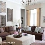 Brown sofa with pillows, artwork, and a coffee table.