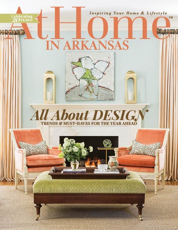 At Home magazine cover featuring a living room with orange seating and a fireplace.
