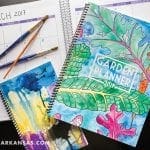 March 2017 calendar, garden planner, and watercolor notebooks with paintbrushes