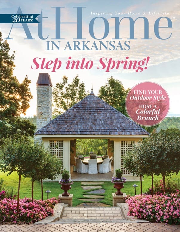 At Home In Arkansas magazine cover with headline 'Step into Spring!' featuring an outdoor dining