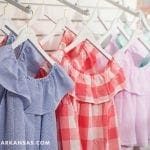 Row of off-the-shoulder children's tops in blue stripes, pink gingham, lavender, and mint green.