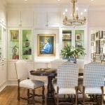 Dining room with white built-in cabinets, a dark wood table, and upholstered chairs.